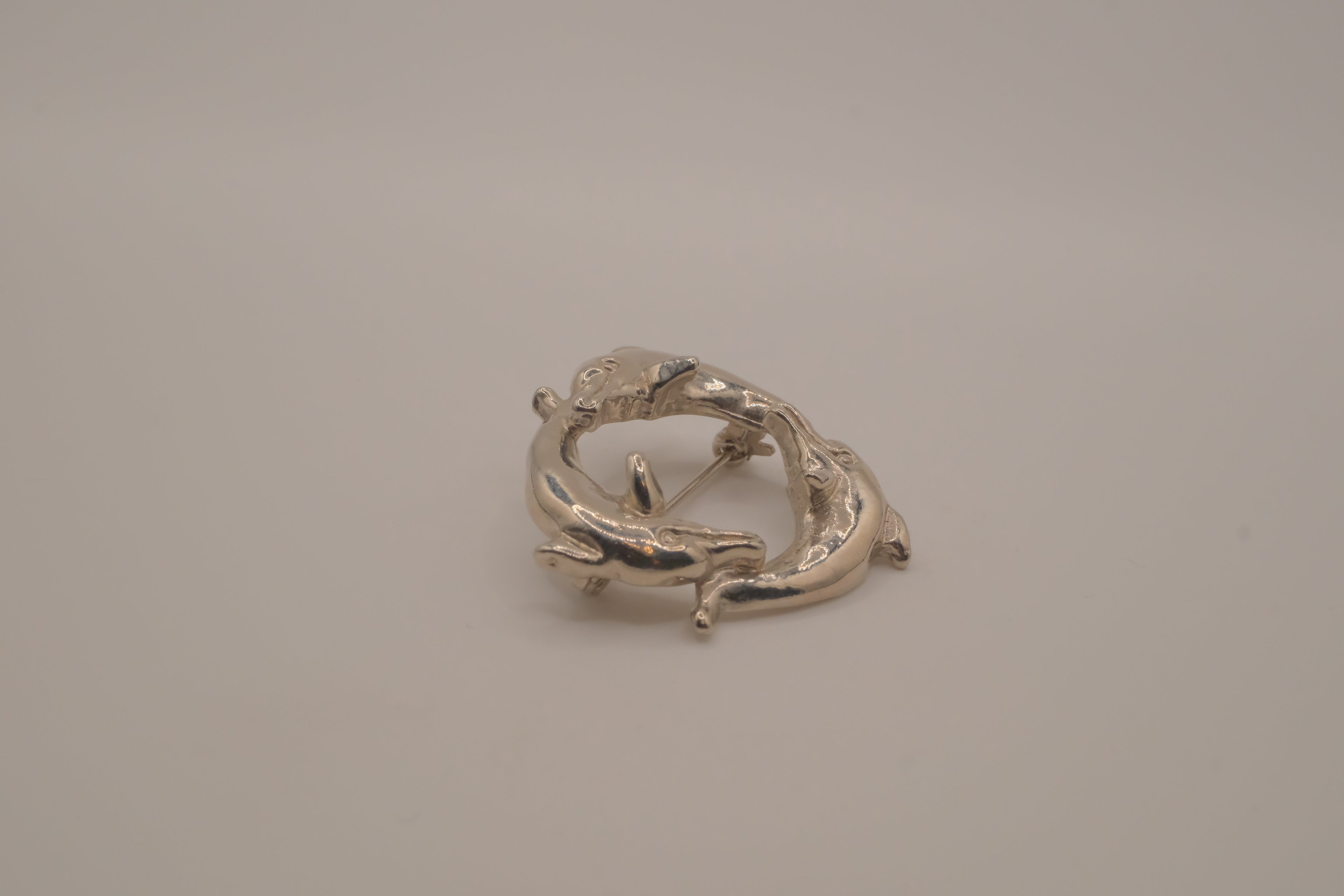 Vintage silver dolphin circle brooch