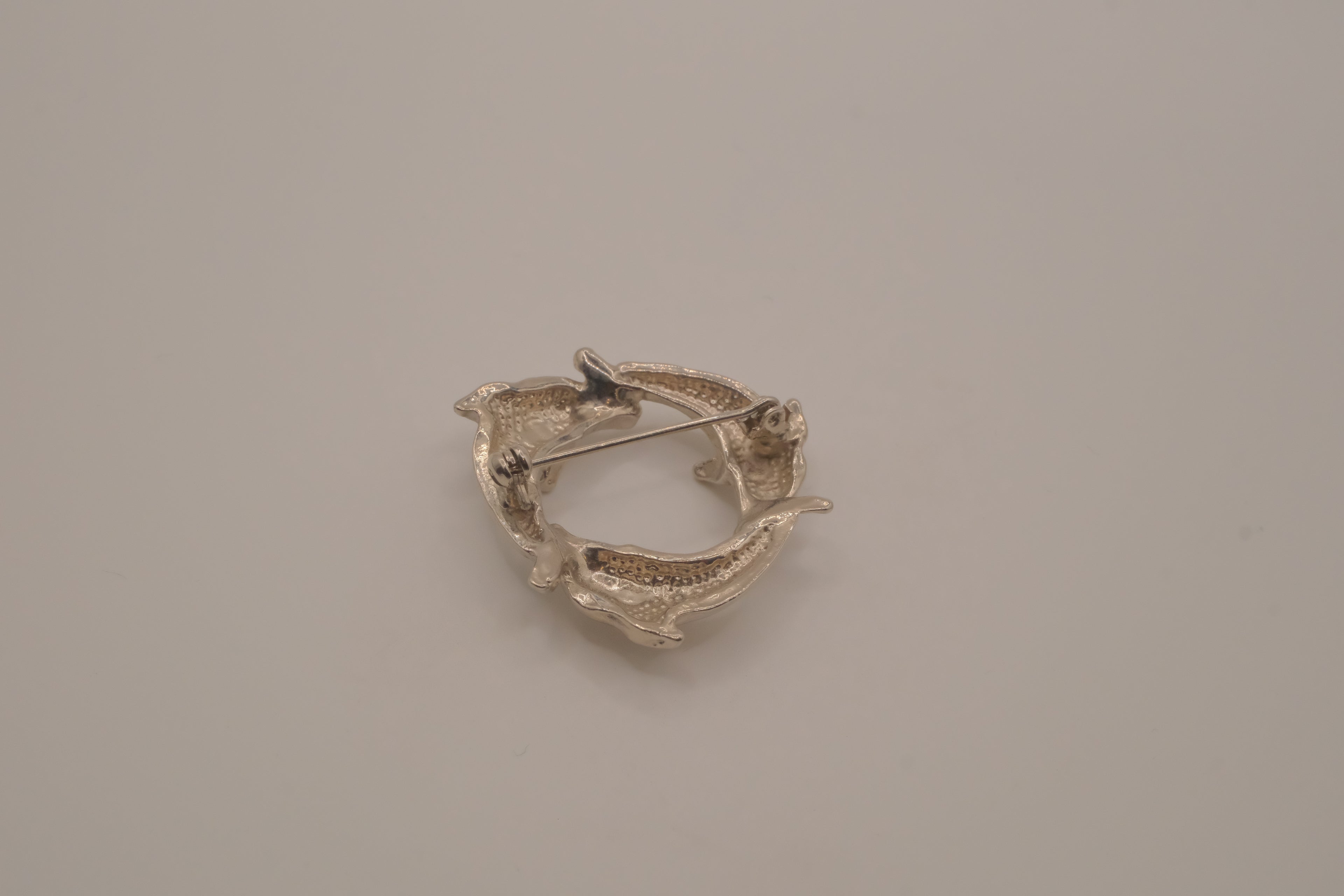 Vintage silver dolphin circle brooch
