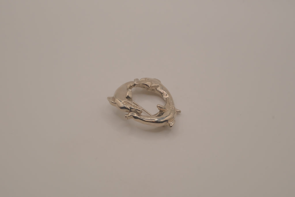 Vintage silver dolphin circle brooch