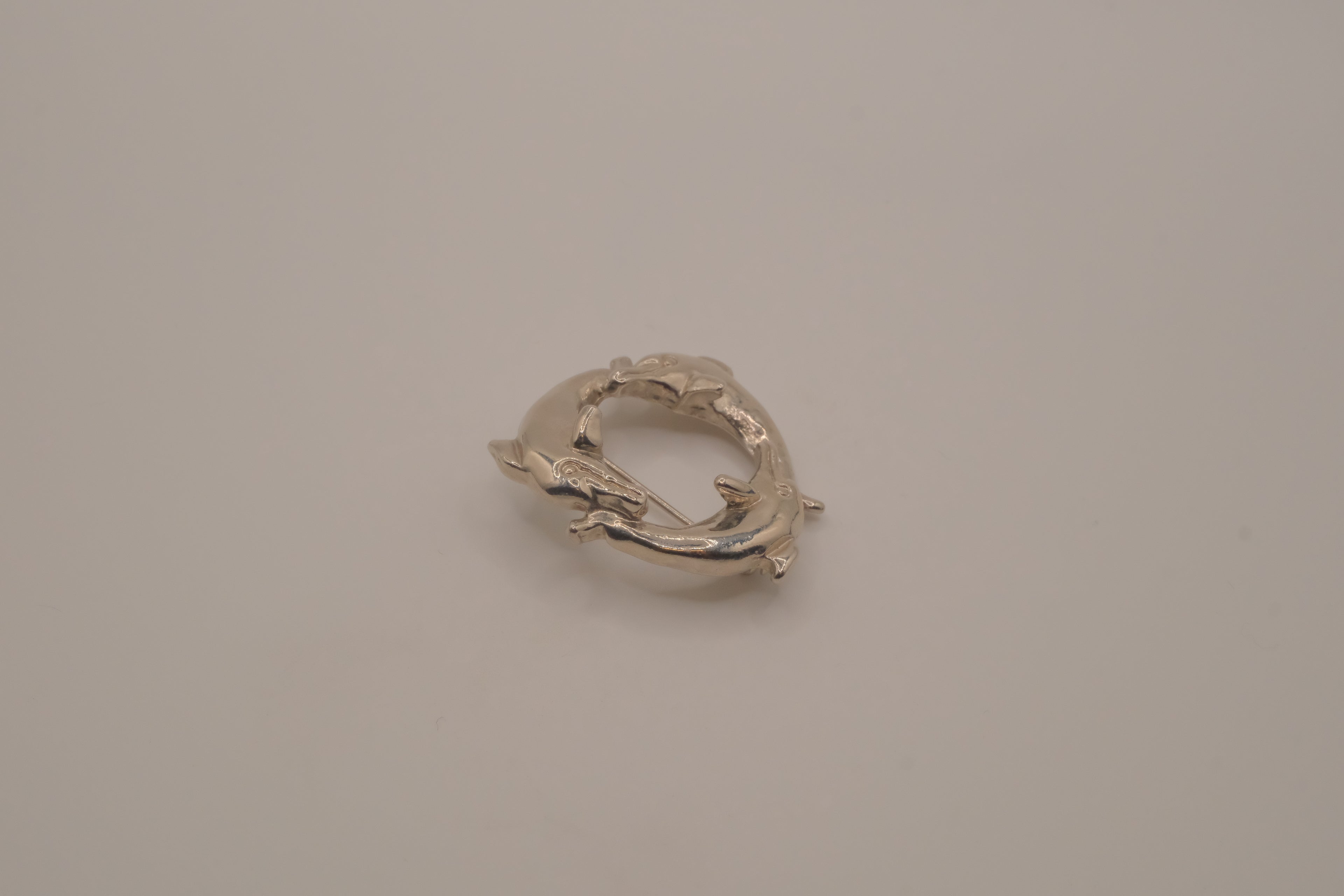 Vintage silver dolphin circle brooch